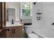 Modern bathroom featuring white tile, vanity, and black fixtures with window for natural light at 114 Heritage St, Summerville, SC 29485