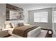 Staged bedroom with wood accent wall, large window, bed, and matching nightstands at 114 Heritage St, Summerville, SC 29485