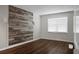 Unfurnished bedroom with hardwood floors, natural light, and an accent wall at 114 Heritage St, Summerville, SC 29485
