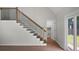 Bright entryway with wood stairs, black iron railing, and a view to the backyard at 114 Heritage St, Summerville, SC 29485