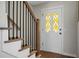Stylish entryway featuring a wood staircase with black iron balusters and a decorative glass front door at 114 Heritage St, Summerville, SC 29485