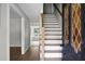 Inviting entryway featuring a beautiful wood staircase and a decorative front door with glass accents at 114 Heritage St, Summerville, SC 29485