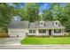 Charming one-story home featuring a well-manicured lawn, two-car garage, and a welcoming front porch at 114 Heritage St, Summerville, SC 29485