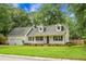 Charming one-story home featuring a well-manicured lawn, two-car garage, and a welcoming front porch at 114 Heritage St, Summerville, SC 29485