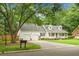 Charming one-story home featuring a well-manicured lawn, two-car garage, and a welcoming front porch at 114 Heritage St, Summerville, SC 29485