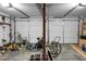 A spacious two car garage with tools and lawn care items, ideal for storage and projects at 114 Heritage St, Summerville, SC 29485