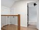 Upstairs hallway with hardwood floors and view into an adjacent bedroom through a doorway at 114 Heritage St, Summerville, SC 29485