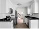 Galley kitchen with white cabinets, granite countertops, and stainless steel appliances at 114 Heritage St, Summerville, SC 29485