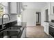 Kitchen featuring stainless steel appliances, white cabinets, and a sink with a large window view at 114 Heritage St, Summerville, SC 29485