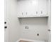 A simple laundry room with white cabinets and basic hookups at 114 Heritage St, Summerville, SC 29485