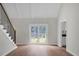 Bright living room featuring hardwood floors, a staircase, and sliding glass doors leading to backyard at 114 Heritage St, Summerville, SC 29485