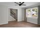 Bright living room showcasing wood floors, stairs with black balusters, and natural light through large window at 114 Heritage St, Summerville, SC 29485