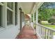 Inviting porch with brick flooring, white railings, and stylish outdoor lighting at 114 Heritage St, Summerville, SC 29485
