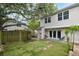 Spacious backyard featuring privacy fence, artificial turf, and outdoor shower at 1161 Monaco Dr, Mount Pleasant, SC 29464