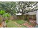 Private backyard with privacy fence, artificial turf, and mature trees at 1161 Monaco Dr, Mount Pleasant, SC 29464