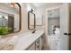 Well-lit bathroom with double mirrors, sleek white countertops, and access to the Primary bedroom at 1161 Monaco Dr, Mount Pleasant, SC 29464