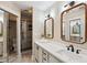Stylish bathroom featuring double mirrors, sleek countertops, and a glass-enclosed shower with modern fixtures at 1161 Monaco Dr, Mount Pleasant, SC 29464