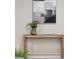 Close up of a wooden table with decorative items, complemented by modern artwork at 1161 Monaco Dr, Mount Pleasant, SC 29464