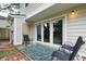 Cozy patio area with outdoor rug, black chairs, and sliding glass doors at 1161 Monaco Dr, Mount Pleasant, SC 29464