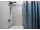 Shower with white textured tiles and blue accent tiles plus modern showerhead at 1161 Monaco Dr, Mount Pleasant, SC 29464