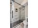 Modern bathroom shower with pebble flooring, glass doors, and white plank-style tile for a spa-like experience at 1161 Monaco Dr, Mount Pleasant, SC 29464