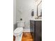 Charming half-bathroom boasts hardwood floors, decorative details, and a stylish vanity at 1211 Dennis Blvd, Moncks Corner, SC 29461