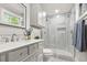 Modern bathroom features a gray vanity, tiled shower with glass door, and updated fixtures at 1211 Dennis Blvd, Moncks Corner, SC 29461