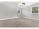 Spacious bedroom with neutral walls, carpet, two windows, and a ceiling fan at 1211 Dennis Blvd, Moncks Corner, SC 29461