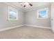 Bright bedroom with neutral walls, carpet, two windows, and a ceiling fan at 1211 Dennis Blvd, Moncks Corner, SC 29461