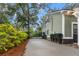 View of a long concrete driveway leading to a black iron gate surrounded by lush greenery at 1211 Dennis Blvd, Moncks Corner, SC 29461