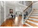 Elegant entryway featuring hardwood floors, staircase, and decorative wrought iron at 1211 Dennis Blvd, Moncks Corner, SC 29461