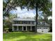 Charming two-story home with a well-maintained lawn, black shutters, and a detached two-car garage at 1211 Dennis Blvd, Moncks Corner, SC 29461