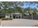 View of a large driveway leading to a stylish green garage with a basketball hoop at 1211 Dennis Blvd, Moncks Corner, SC 29461