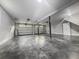 Spacious two-car garage with gray flooring, white walls, overhead lighting, and ample storage space at 1211 Dennis Blvd, Moncks Corner, SC 29461
