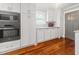 Modern kitchen with stainless steel appliances, white cabinets, and hardwood floors at 1211 Dennis Blvd, Moncks Corner, SC 29461