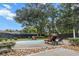 A backyard pool surrounded by lounge chairs and beautiful landscaping offers a relaxing retreat at 1211 Dennis Blvd, Moncks Corner, SC 29461