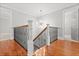 Elegant staircase with hardwood floors, black iron railings, and white accents at 1211 Dennis Blvd, Moncks Corner, SC 29461