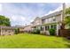 Expansive backyard featuring a well-maintained lawn, patio area, sunroom, and beautifully landscaped surroundings at 125 Spring Meadows Dr, Summerville, SC 29485