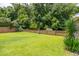 Spacious backyard features a lush lawn, privacy fence, and mature trees at 125 Spring Meadows Dr, Summerville, SC 29485