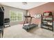 Carpeted bedroom with a treadmill, whiteboard, and shelving unit at 125 Spring Meadows Dr, Summerville, SC 29485