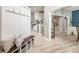 Open foyer with wood-look floors and convenient built-in bench and coat rack at 125 Spring Meadows Dr, Summerville, SC 29485