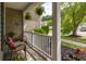 Cozy front porch featuring comfortable seating, hanging plants, and a view of the landscaped front yard at 125 Spring Meadows Dr, Summerville, SC 29485