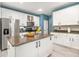 Bright kitchen features white cabinets, stainless steel appliances, and an island with a granite countertop at 125 Spring Meadows Dr, Summerville, SC 29485