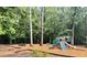 Scenic playground with swings and slide equipment nestled among mature trees and mulch ground cover at 125 Spring Meadows Dr, Summerville, SC 29485