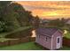 Picturesque backyard pond view at sunset, complete with shed and classic wooden fence at 125 Spring Meadows Dr, Summerville, SC 29485
