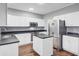 Modern kitchen featuring white cabinets, stainless appliances, and a center island with black countertops at 1253 Horseshoe Bnd, Mount Pleasant, SC 29464