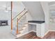 View of the carpeted staircase with wood trim leading to the upper level, with a built-in desk nook at 1253 Horseshoe Bnd, Mount Pleasant, SC 29464