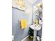 Charming half bath featuring a pedestal sink and decorative mirror at 126 Thousand Oaks Cir, Goose Creek, SC 29445