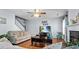 Inviting living room featuring a cozy couch, wood floors, ceiling fan, and a fireplace at 126 Thousand Oaks Cir, Goose Creek, SC 29445