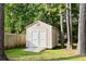 Backyard shed with double doors and ramp, surrounded by mature trees in a green lawn at 126 Thousand Oaks Cir, Goose Creek, SC 29445